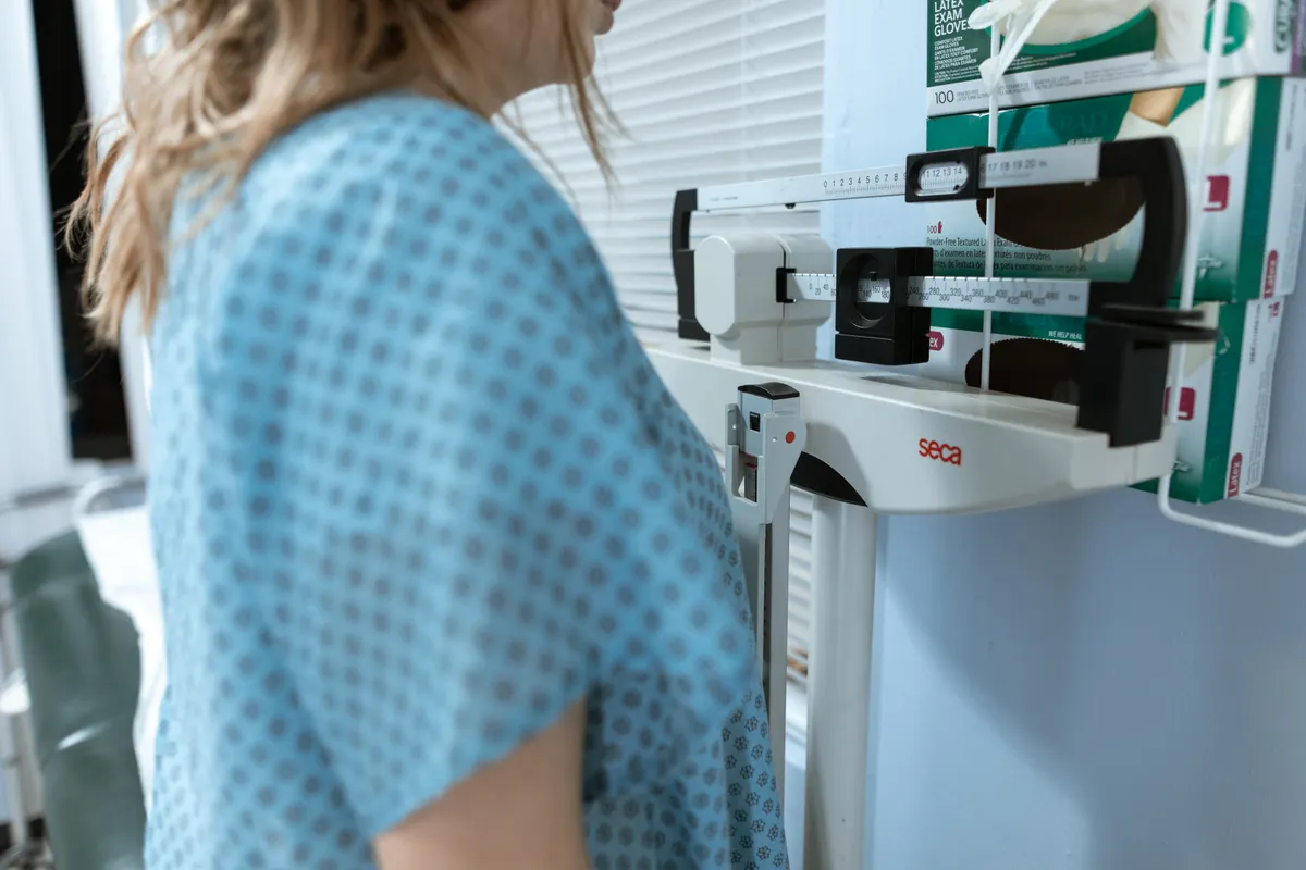 A person being measured at a body-composition analyser.